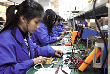 Workers in Hefei, China, assemble remote control panels for air conditioners and water heaters.