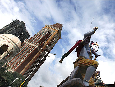 Hindu devotees carry a large statue of Ganesh, the Hindu deity of prosperity.