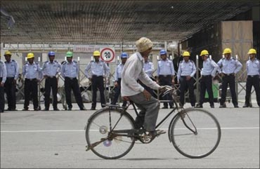 A man rides his bicycle infront of the Manesar plant.