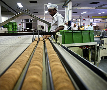 A worker sorts broken biscuits on a conveyor belt at the Britannia factory.