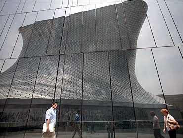 People walk outside the Soumaya Museum in Mexico City.