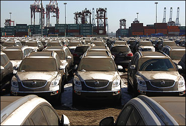 Dust-covered SUVs lie in a port.