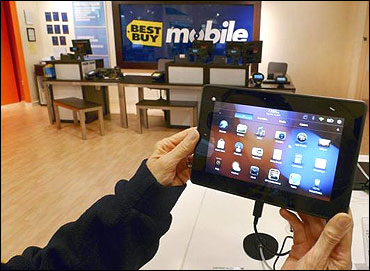 A customer holds a Research In Motion's PlayBook tablet computer in Fairfax, Virginia.
