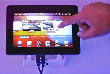 A conference attendee examines the BlackBerry PlayBook during its launch in Mumbai.