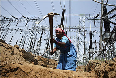 A labourer works at the construction site of a grid power station.