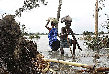 Flood-affected villagers make their way through a cyclone-hit area in the Sundarbans delta.