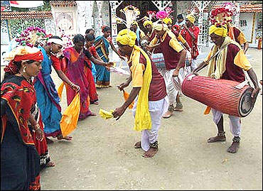 Tribal people from Chhattisgarh beat drums as they dance.