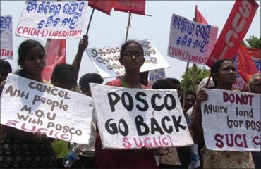 Villagers hold placards during a protest against Posco.