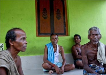 Villagers sit at the entrance to a house in Gobindpur.