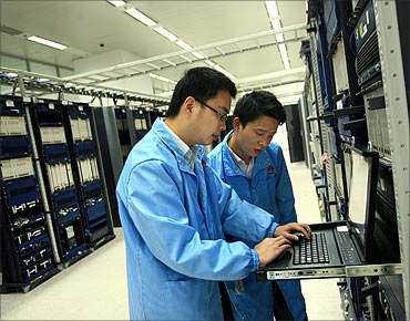 Huawei R and D staff performing routine maintenance.