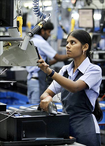 An employee assembles a computer on the production line at a Dell factory in Sriperumbudur.