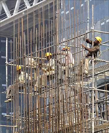 Labourers work at a construction site.