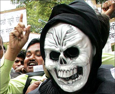 An Indian trader wears a mask during a protest against the Value Added Tax (VAT),