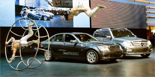 Artists perform as a Mercedes-Benz 200 CDI Blue Efficiency car and a GLK Bluetec Hybrid (R) car are presented.
