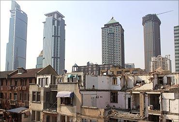 A migrant labourer works at a demolished residential site in downtown Shanghai.