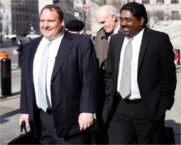 Galleon hedge fund founder Raj Rajaratnam (R) leaves federal court after a hearing in New York.