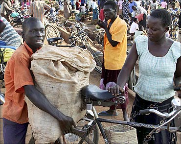 A man selling cassava pushes his goods through Lira Market in northern Uganda