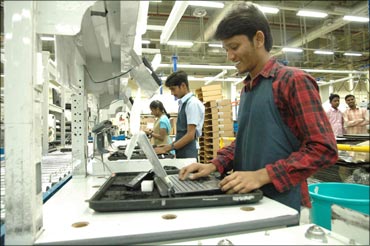 Rural Indians working at the Dell laptop assembly line in Sriperumbudur.