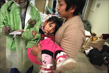 An injured girl is brought to a Japanese Red Cross hospital.