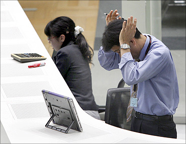 Employees of the Tokyo Stock Exchange (TSE) work at the bourse in Tokyo.