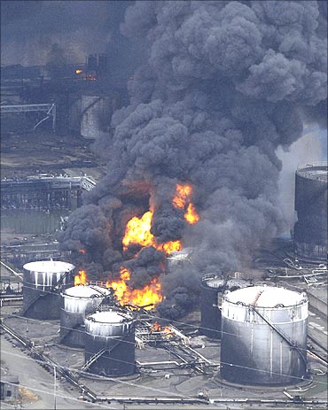 A factory facility burns following an earthquake and tsunami in Sendai.
