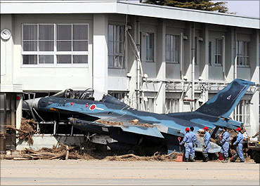 A Mitsubishi F-2 fighter aircraft of the Japanese Air Self-Defense Force swept into a building.