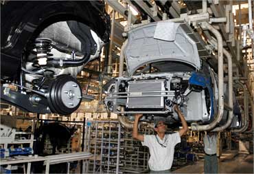 Workers assemble a car at a Maruti Suzuki plant in Manesar.