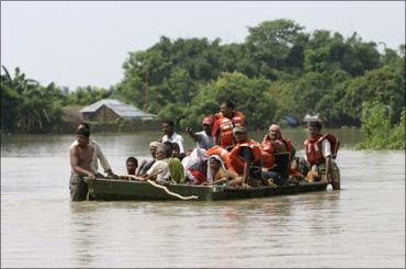 Villagers negotiating a flooded river in Bihar.