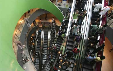 Shoppers ride the escalators at VivoCity shopping mall in Singapore.