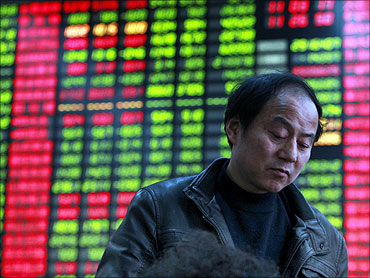 A man monitors stock prices at a securities trading firm.