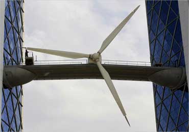 A worker cleans a wind turbine at the Bahrain World Trade Center Building in Manama.