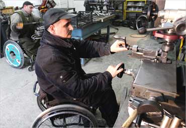 Disabled men work at a wheelchair assembly shop in Tbilisi, Georgia.