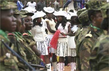 Cheerleaders seen through a line of soldiers at a rally during National Day celebrations in Bangui.