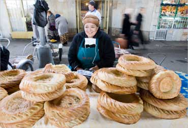 A woman sells traditional Uzbek bread at a market in Tashkent.