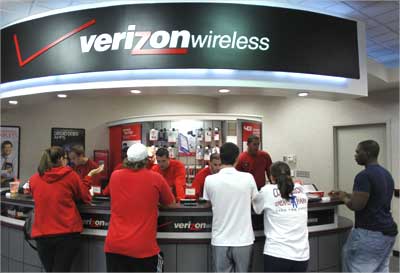 Customers purchase the iPhone 4 with the Verizon Wireless network in Boca Raton, Florida.