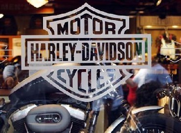 Motorcycle maker Harley Davidson's logo appears on the window of a store