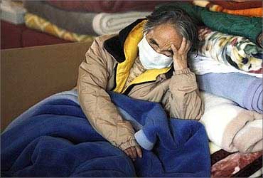 A refugee sleeps at a relief center in Minamisanriku town, Miyagi prefecture.