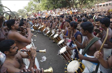 Musicians perform during the procession at the Pooram festival held at the Vadakkumnatha temple.
