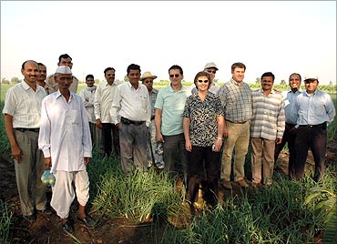 Hemchandra Patil in his field with foreign visitors.