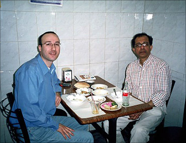 Eating humus at Lina's, in Old Jerusalem, with Hosni Zoabi, 2005.