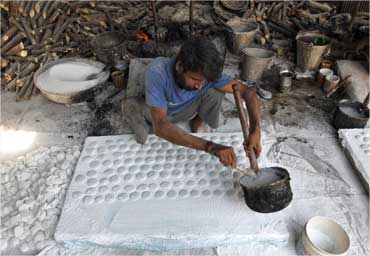 A labourer works inside a sugar-candies manufacturing industry in Ahmedabad.