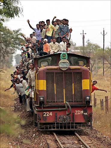 Villagers travel by train on the outskirts of Raipur.