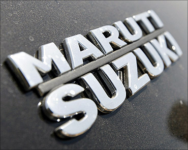 The brand name of Maruti Suzuki pictured on a Swift car.