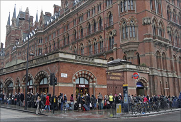 Eurostar passengers queue outside the terminal for trains at St Pancras station in London.