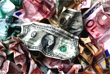A picture illustration of crumpled kuna, dollar and euro banknotes.