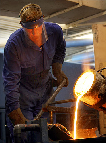A worker casts an ingot of gold at Kolyma Refinery in the village of Khasyn, Russia.
