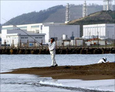 A man fishes near Tokyo Electric Power Co.'s (TEPCO) Kashiwazaki-Kariwa nuclear plant.