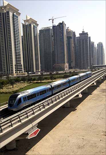 A Dubai Metro train runs past Sheikh Zayed road in Dubai