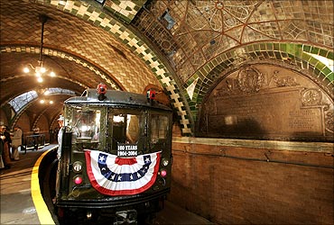 A vintage Low V subway car stands in the original City Hall subway station.