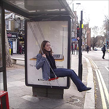 A bus stop with a swing.